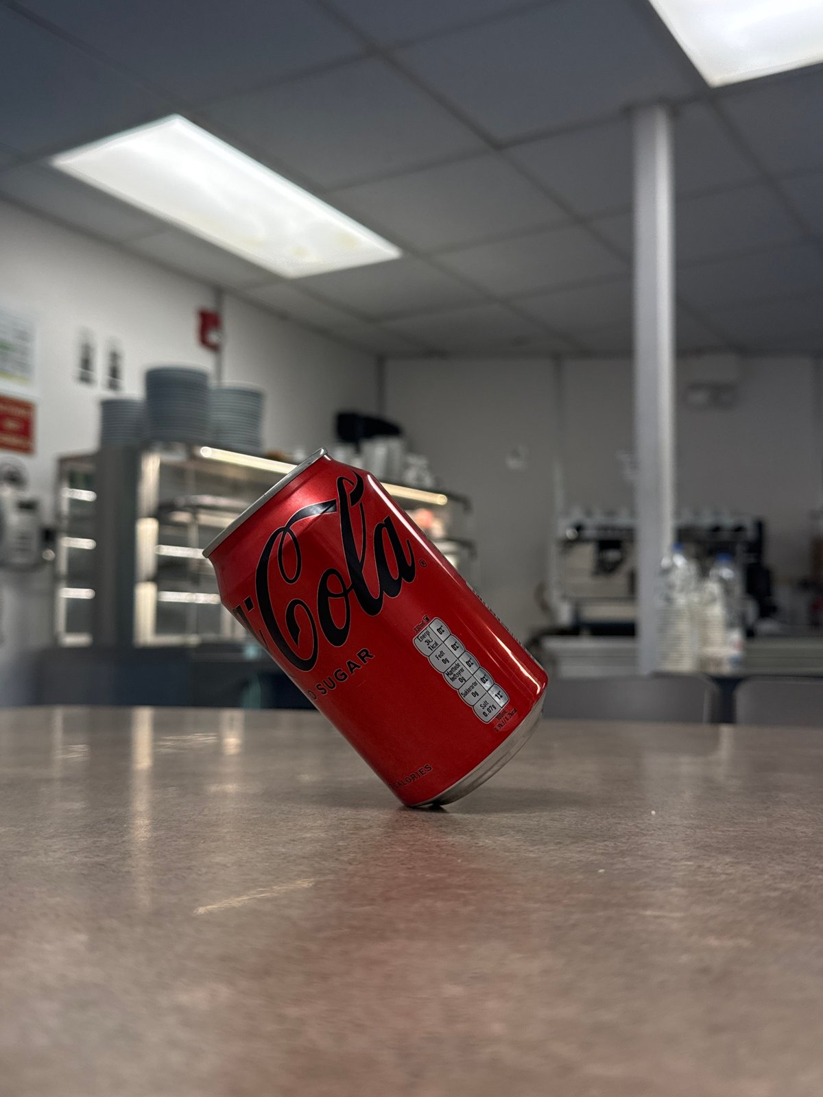 Coke Zero can balanced on a water bottle, Italy