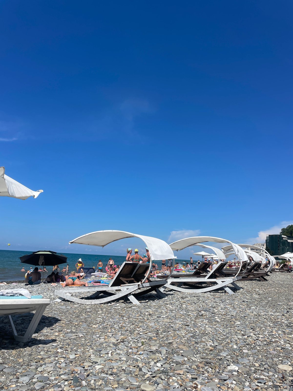 Busy summer morning on Sochi's Black Sea pebble beach