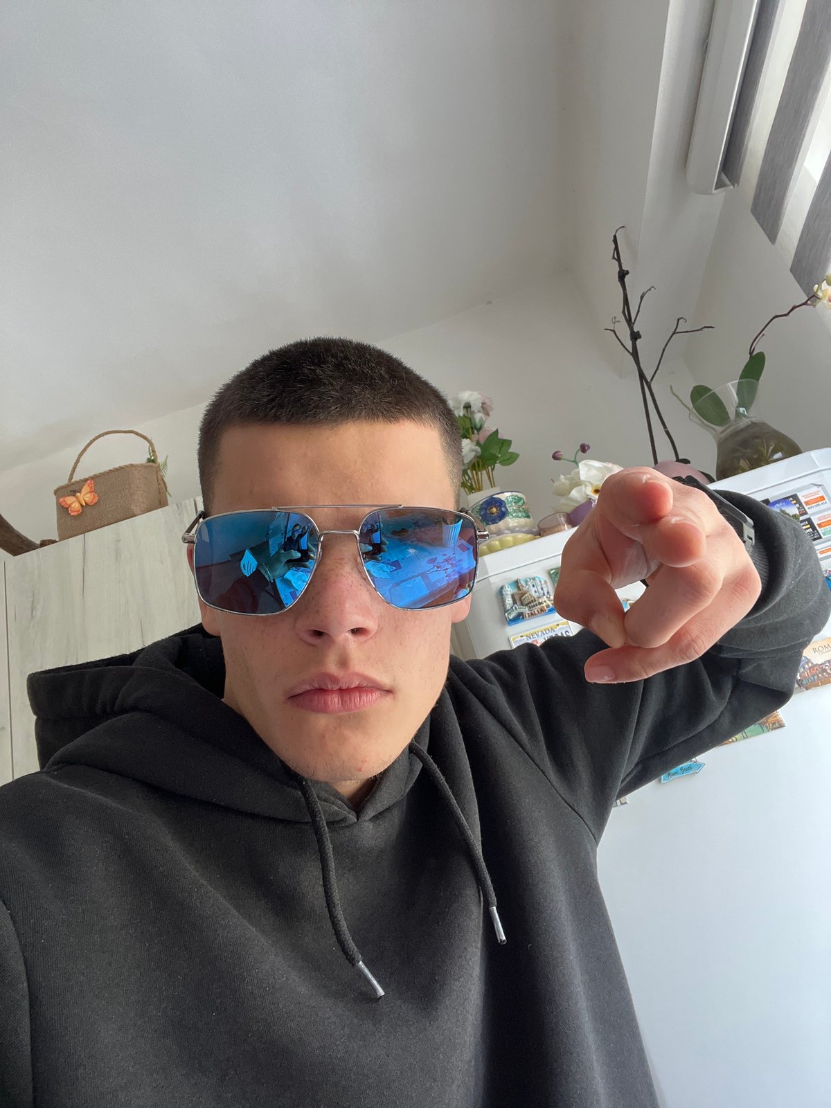 Person in sunglasses poses playfully indoors in Sopot, Bulgaria