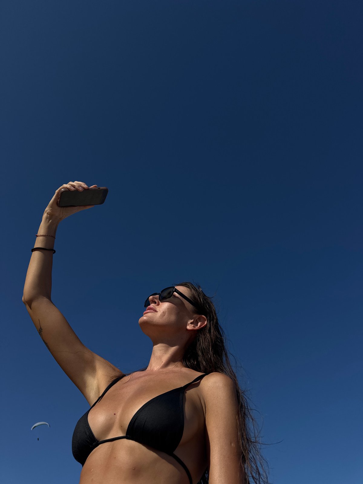 Beach selfie session on Kuta Selatan's shoreline, Bali