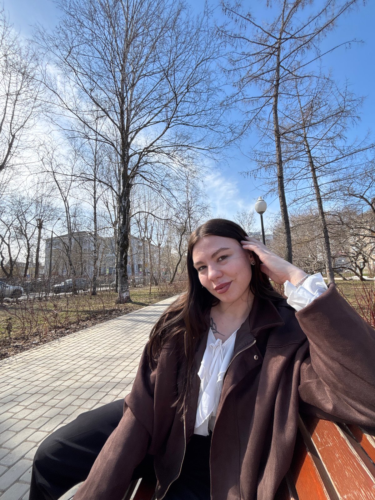 Woman sits on park bench in Perm, Russia