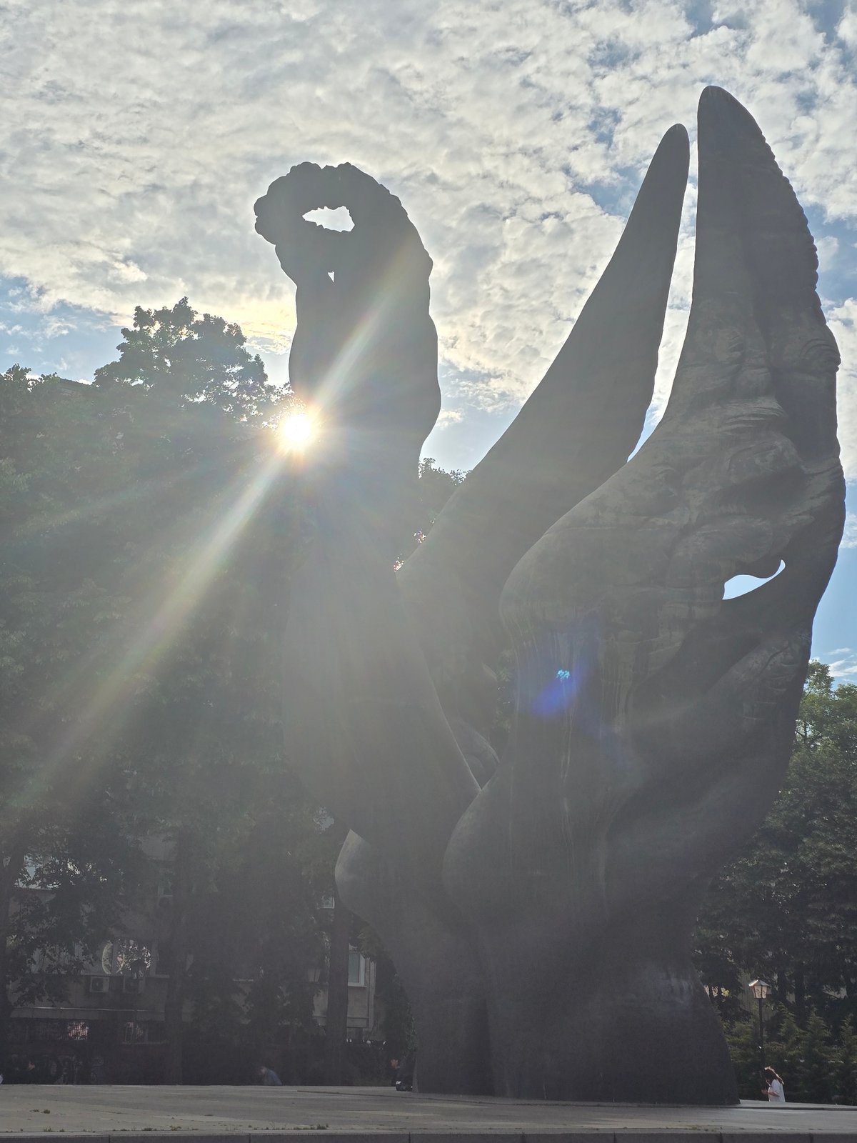 Urban afternoon scenes: traffic, sculptures, parked cars documented