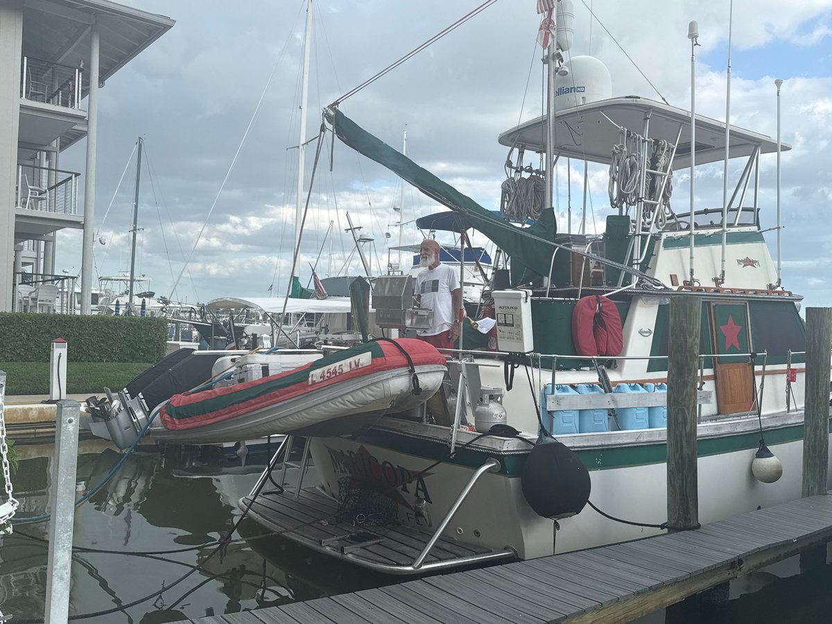Yacht Maricopa docked at Naples marina with crew activity