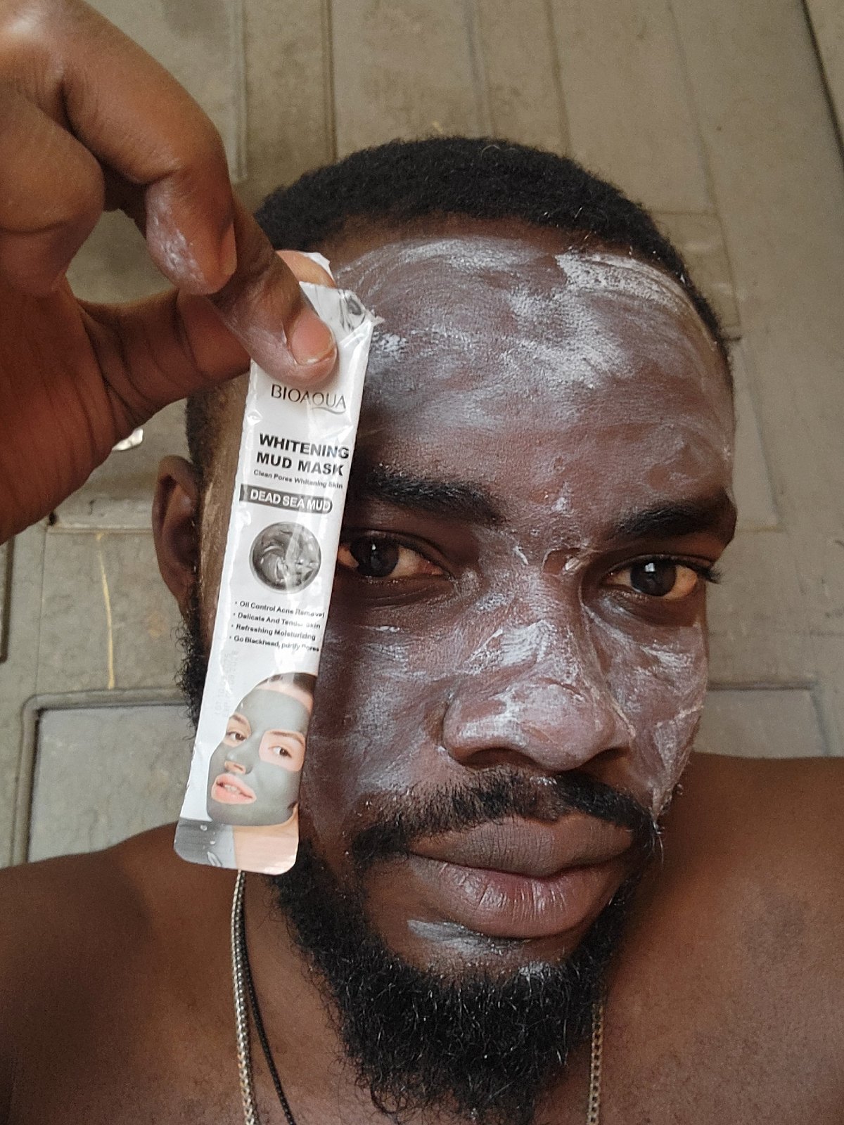 Man applies facial masks during skincare routine in Jos