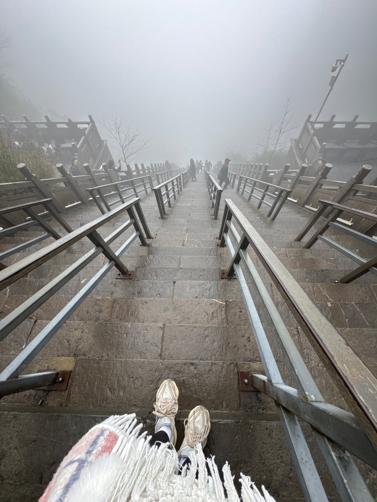 Tourist documents foggy morning exploration of Zhangjiajie's Heavenly Gate Mountain