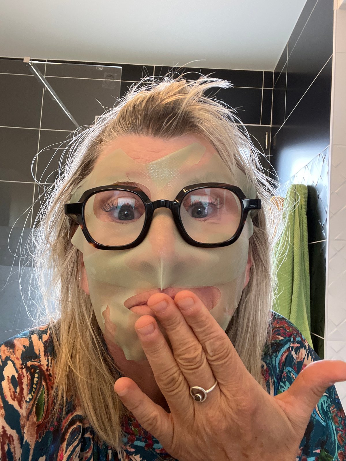 Woman applies facial mask during afternoon skincare routine in France