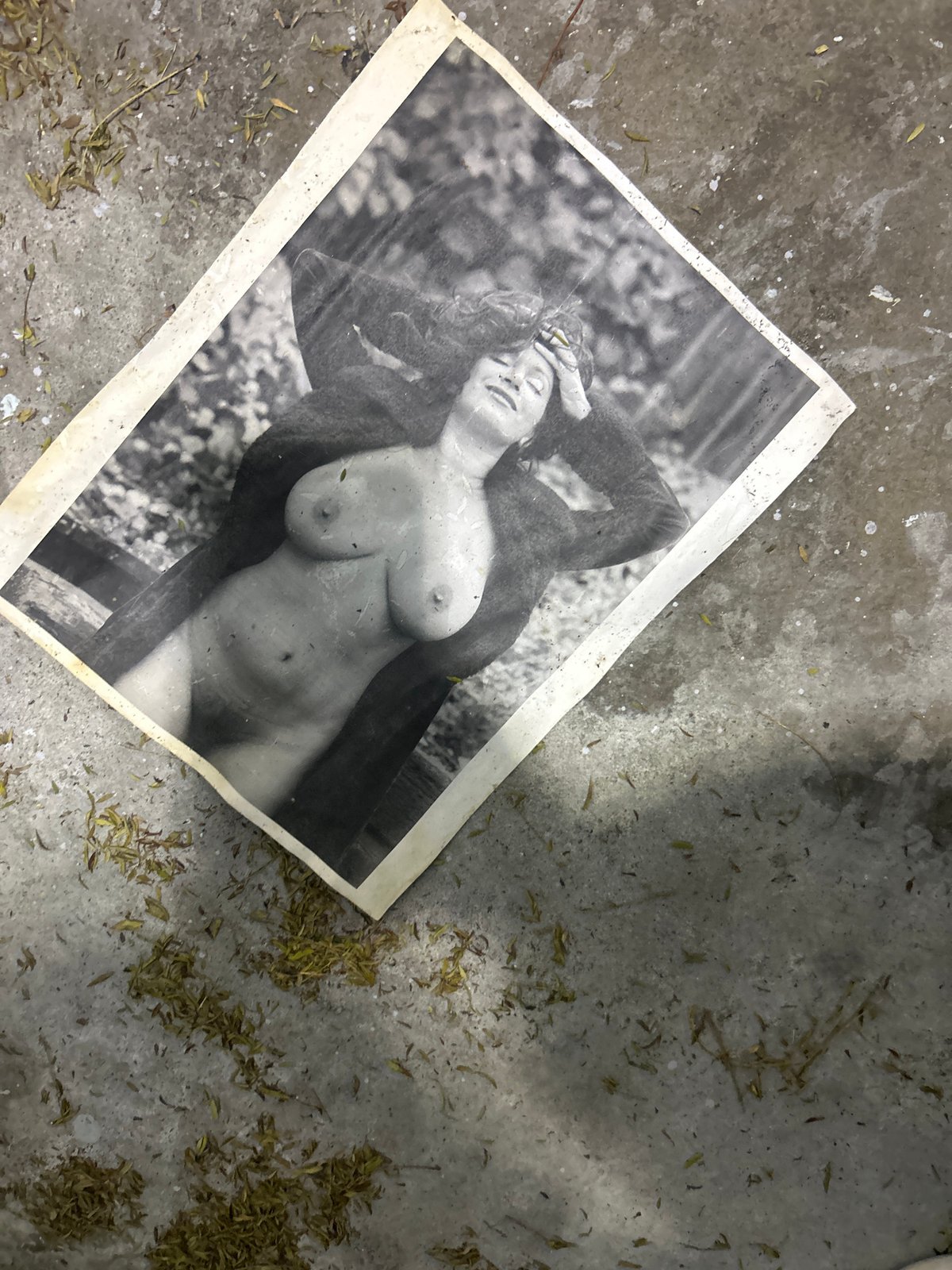 Discarded nude photograph found on concrete surface in Los Angeles