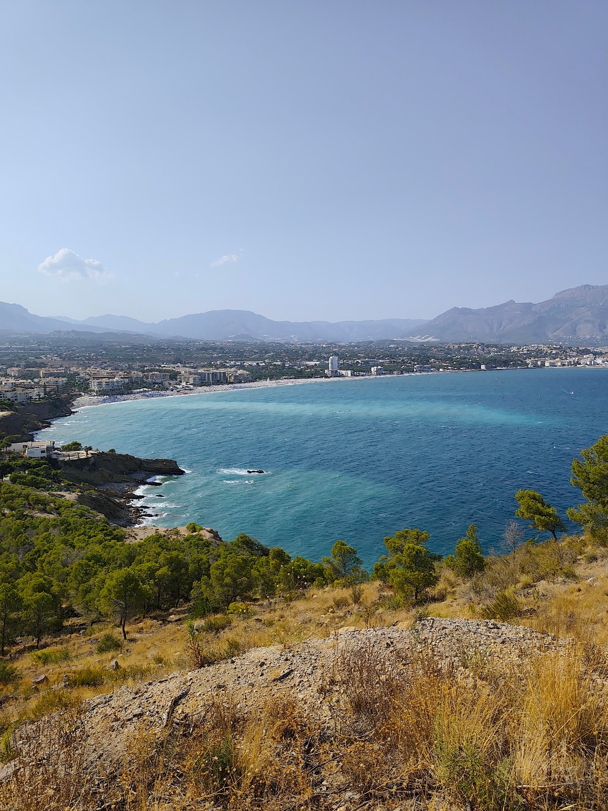 Rocky Mediterranean hillside with tunnel path and sea views