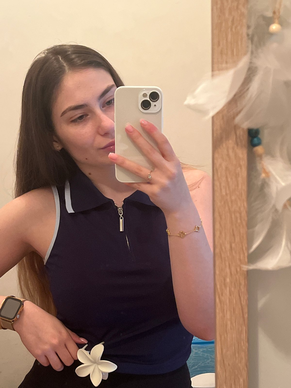 Woman documents mirror selfie session in home setting