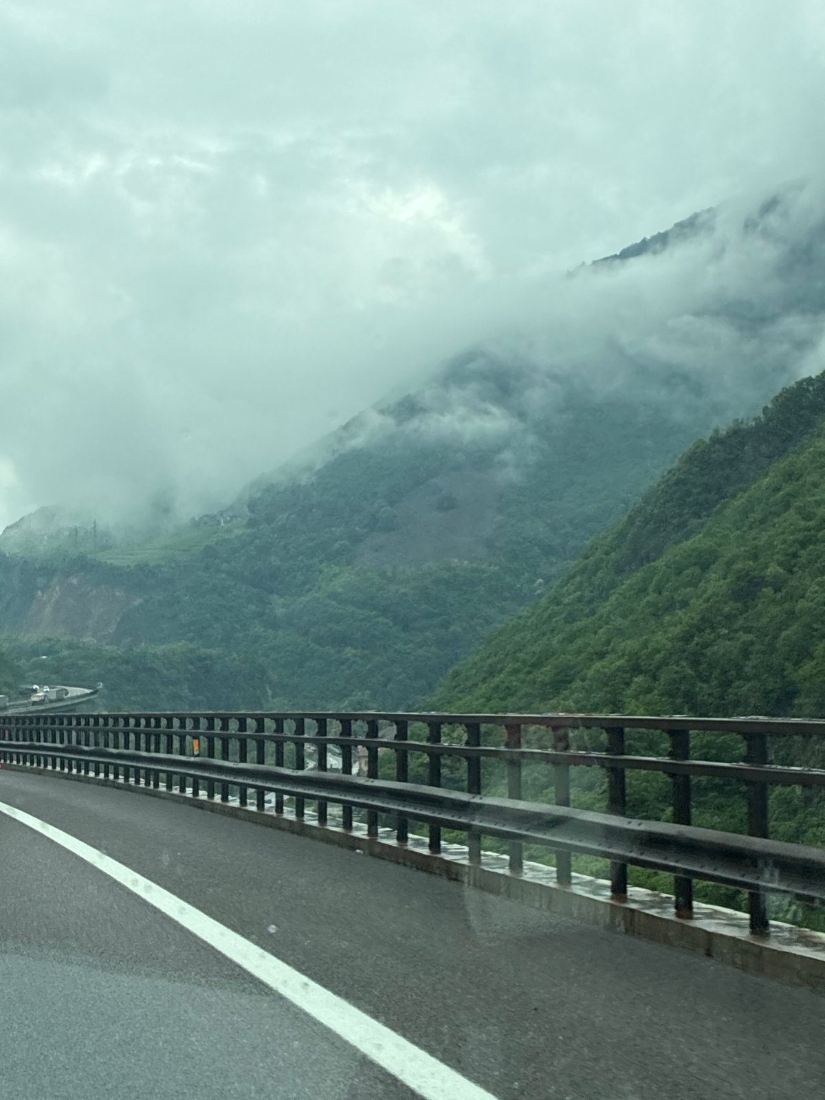 Morning fog observed from roadway in Italian Alpine village