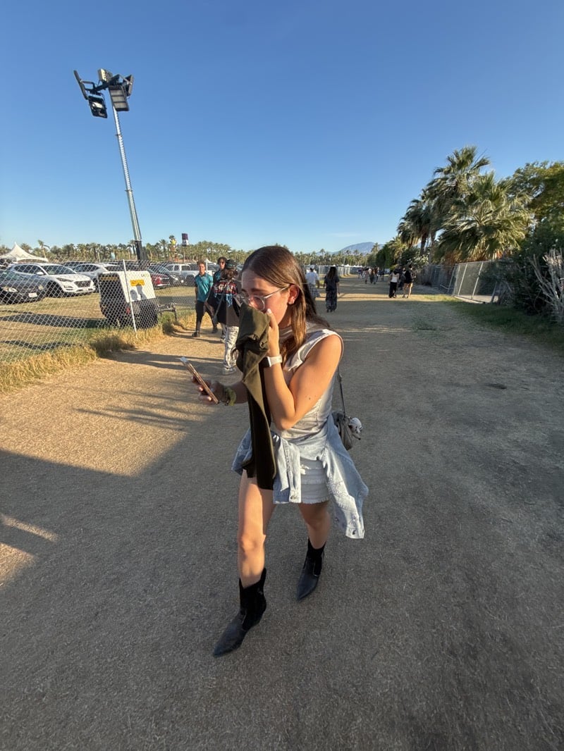 Young women walk festival grounds in Indio, California