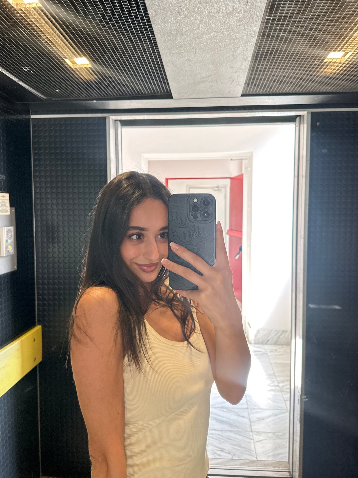 Woman takes selfies in Milan elevator, enjoys cookie break