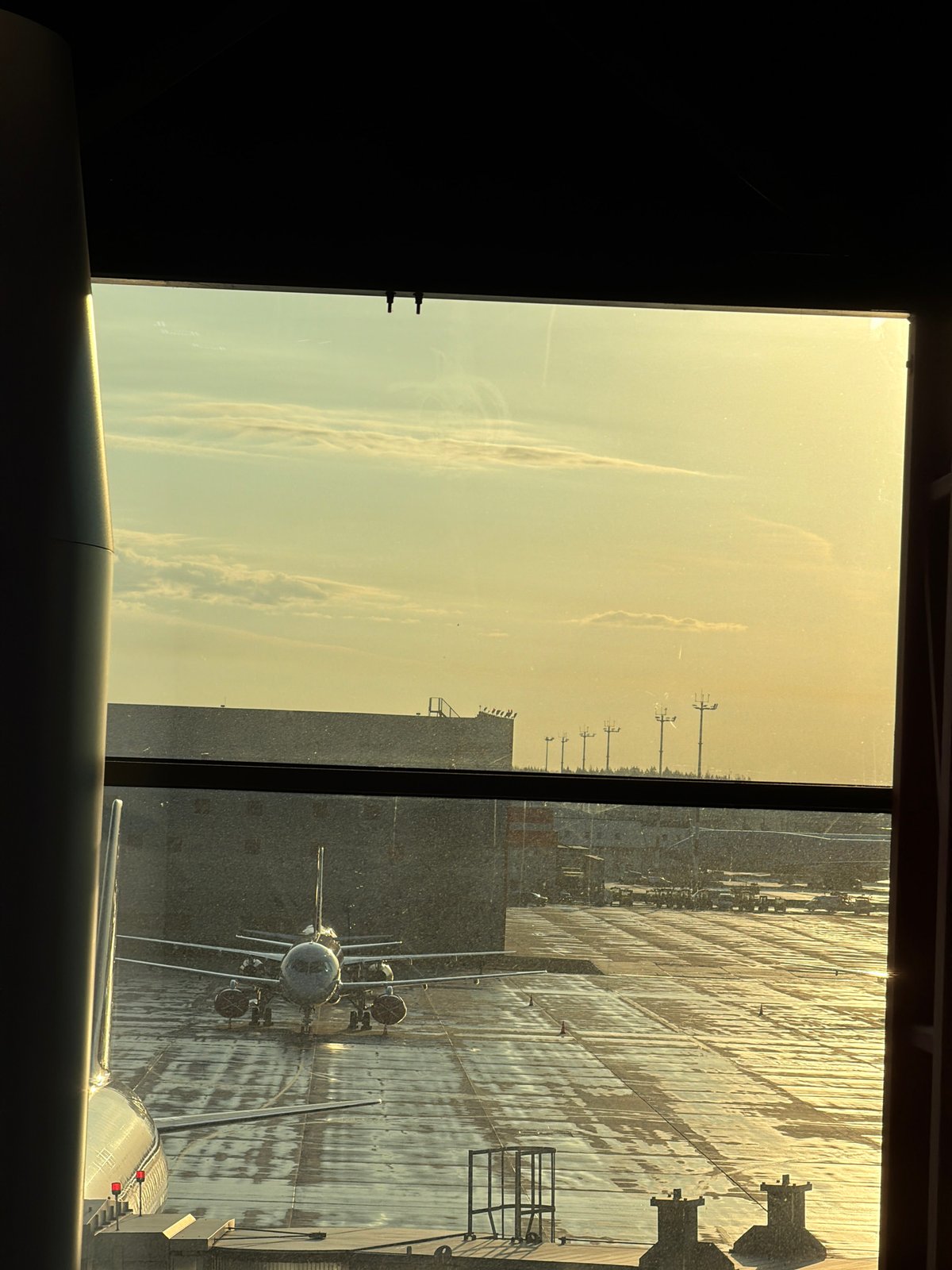 Early morning airport scene captured with aircraft, wet tarmac