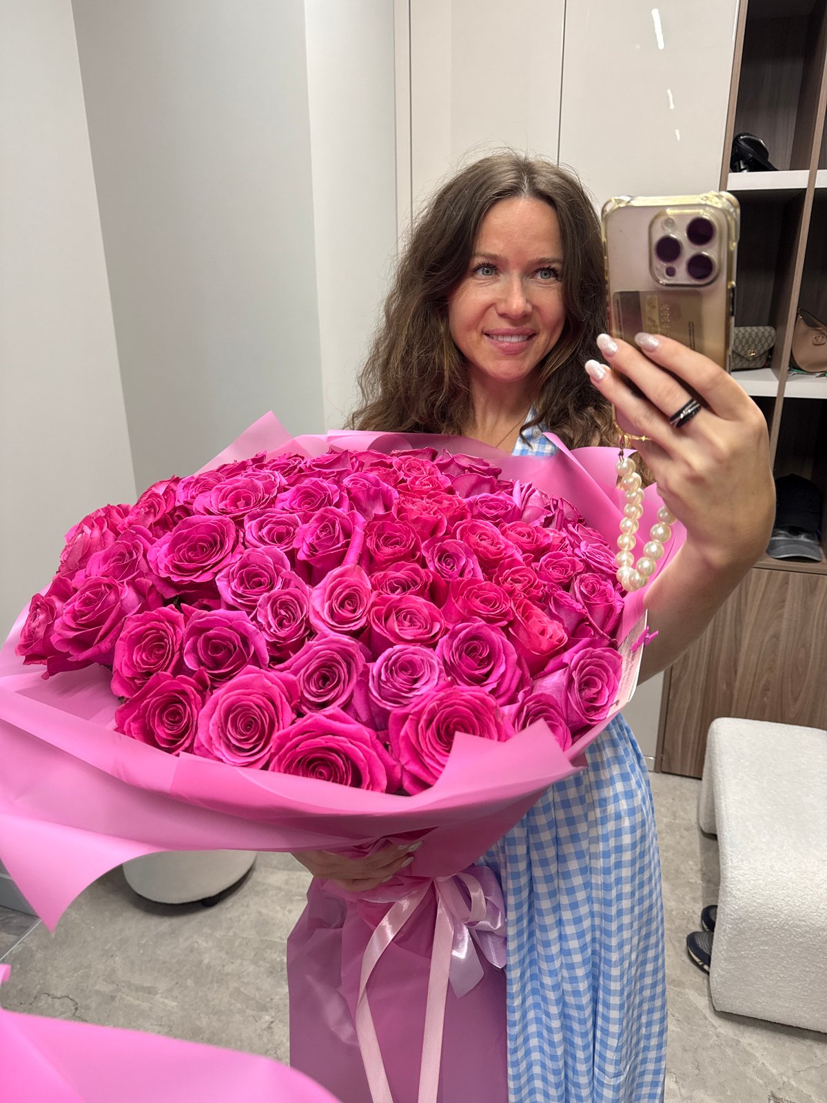 Selfie moment with a dense bouquet of pink roses in Moscow