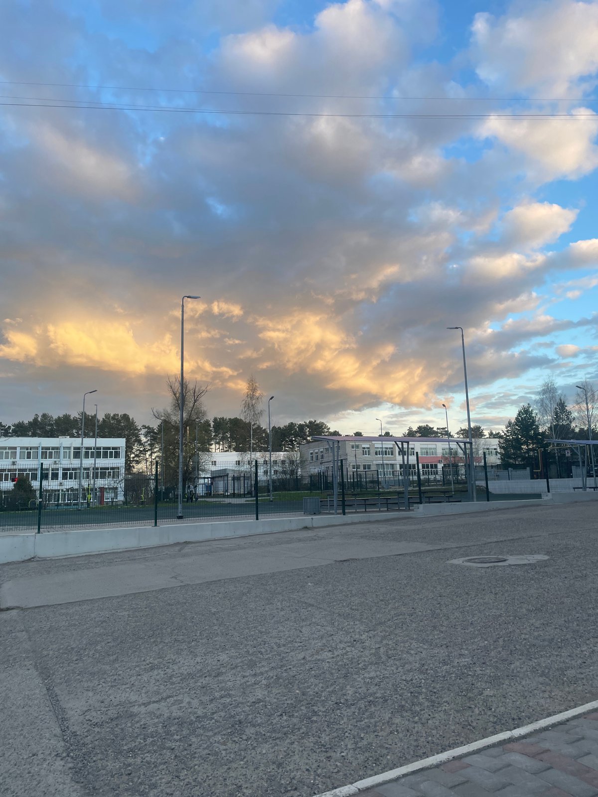 Roadside landscape captured showing dramatic sky over urban area