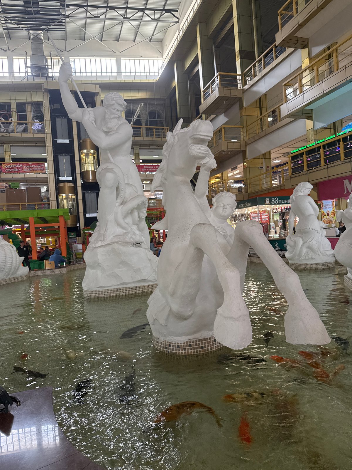 Indoor fountain with white sculptures observed in Nakhodka mall