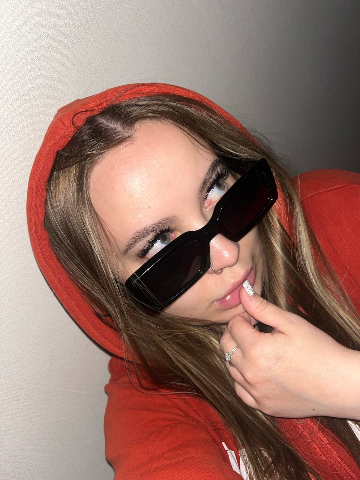 Person in orange hoodie photographed relaxing indoors in Krasnodar