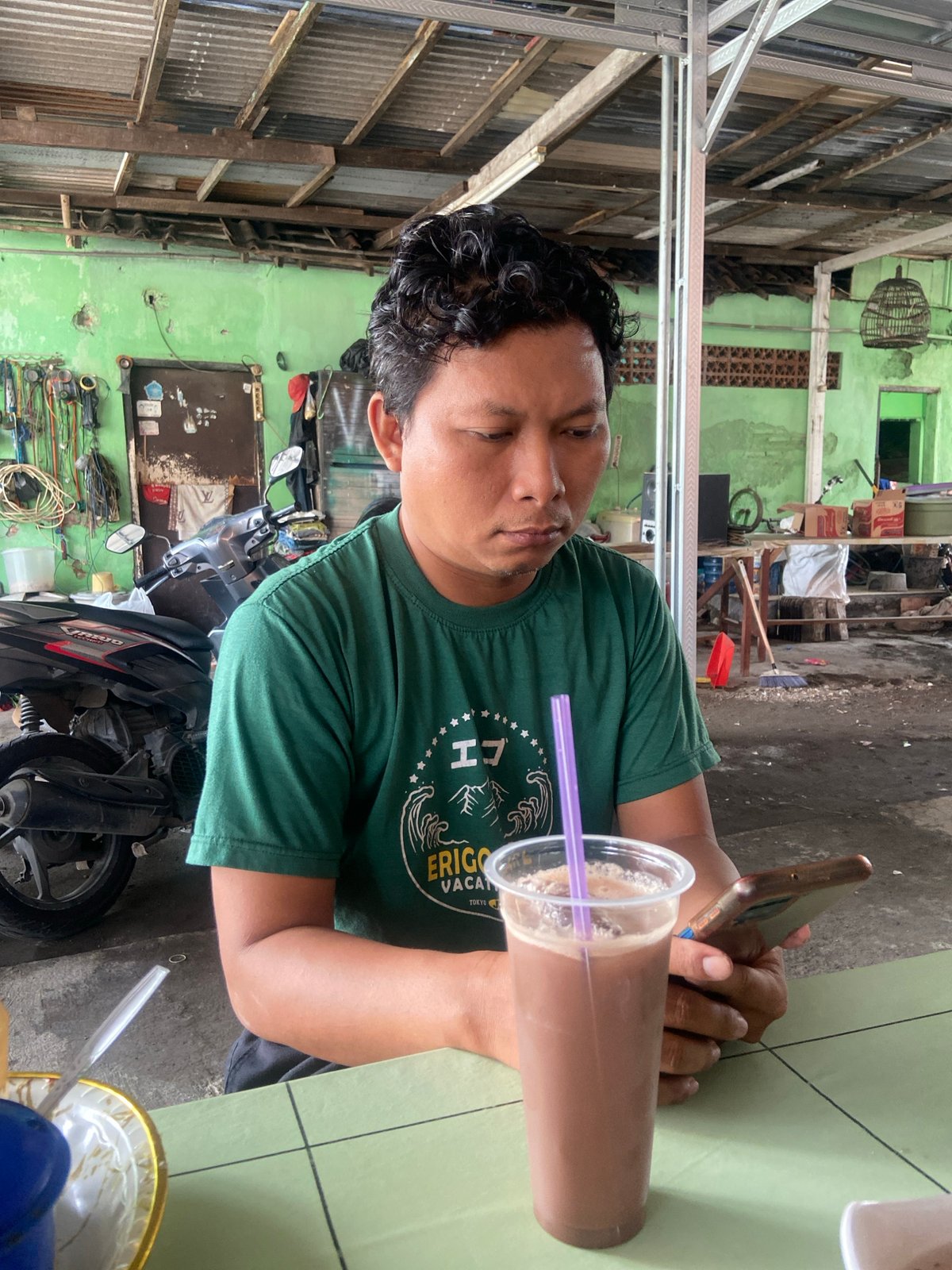 Family meal shared outdoors in Gelam, Indonesia