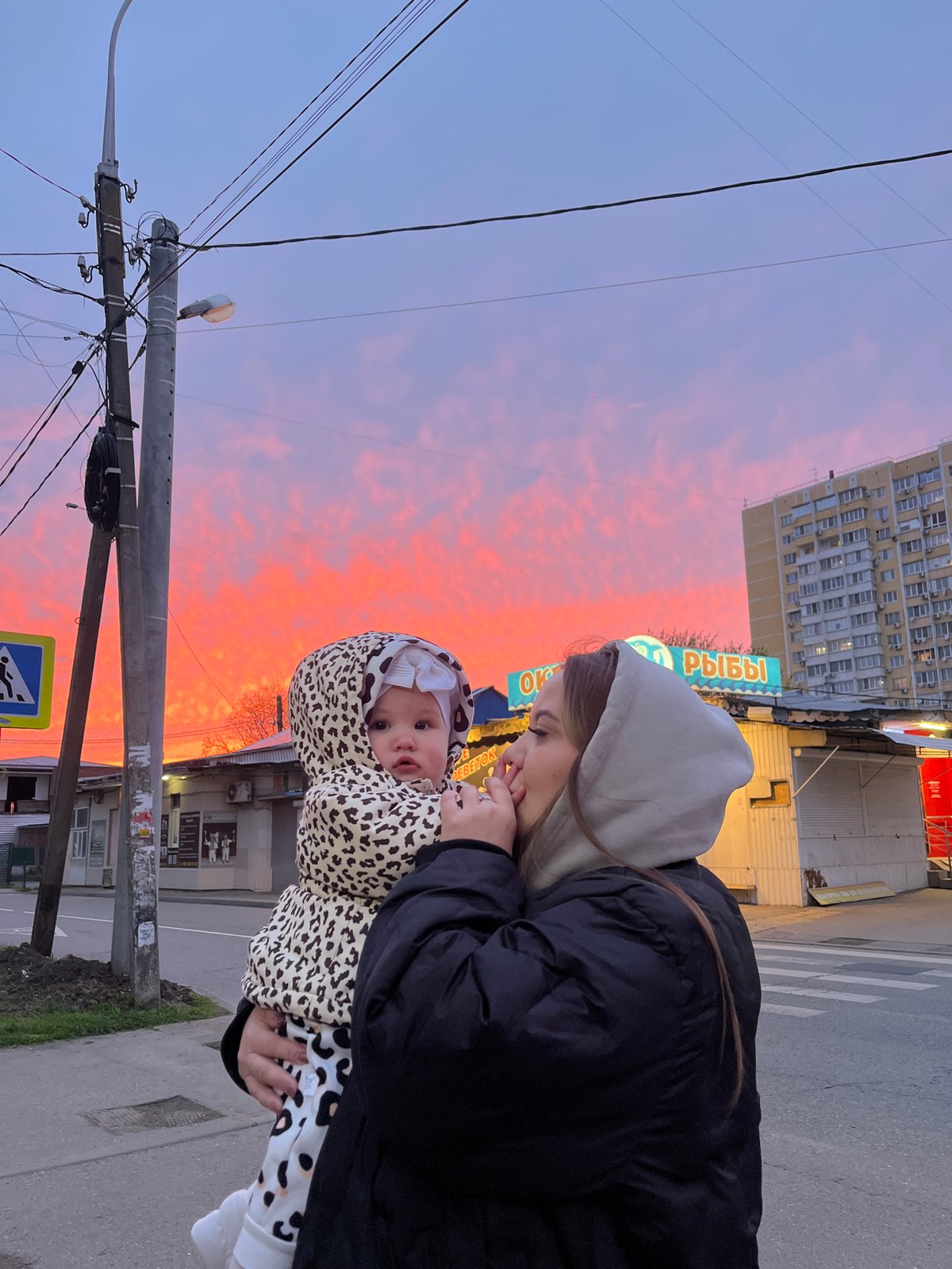Woman and baby share tender moment during Krasnodar sunset