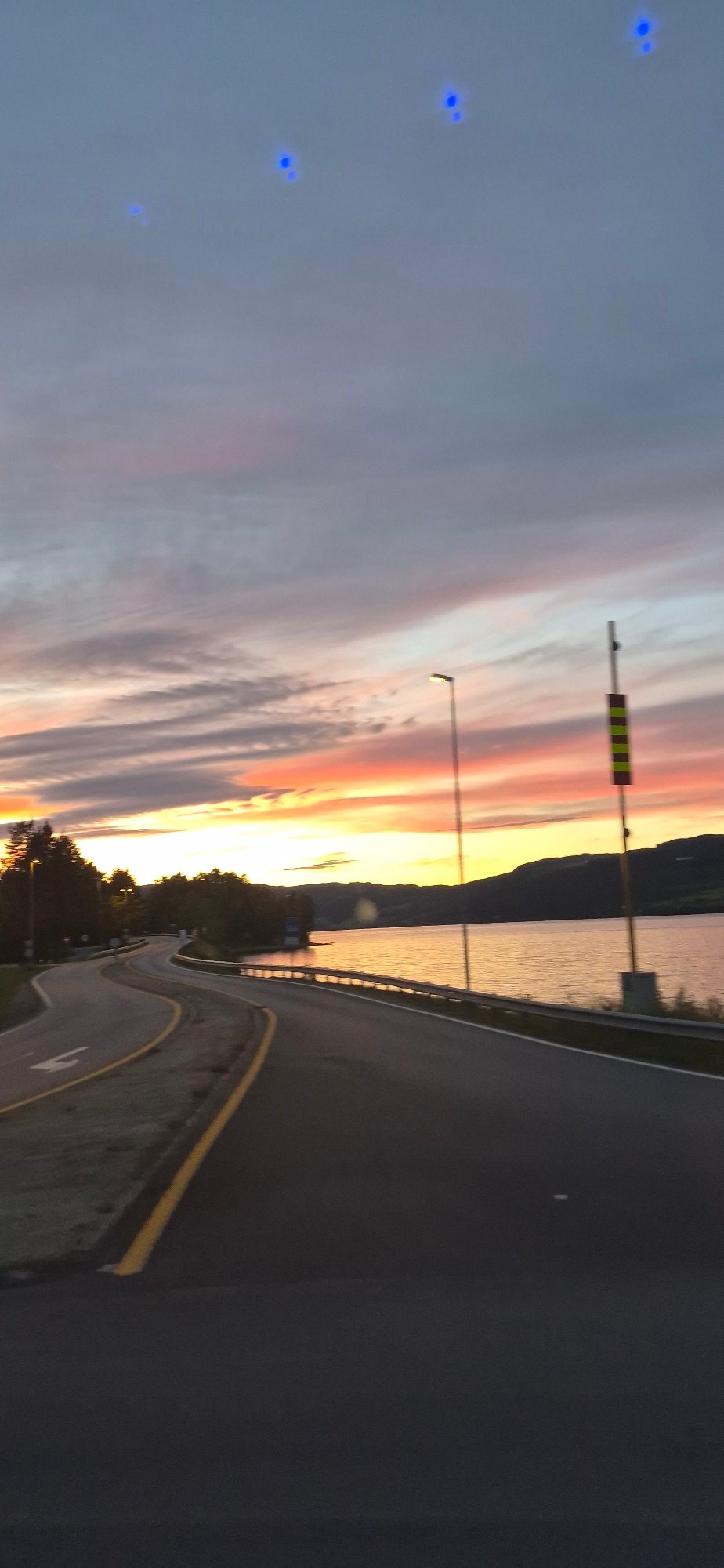 Summer twilight colors over a Norwegian fjord road