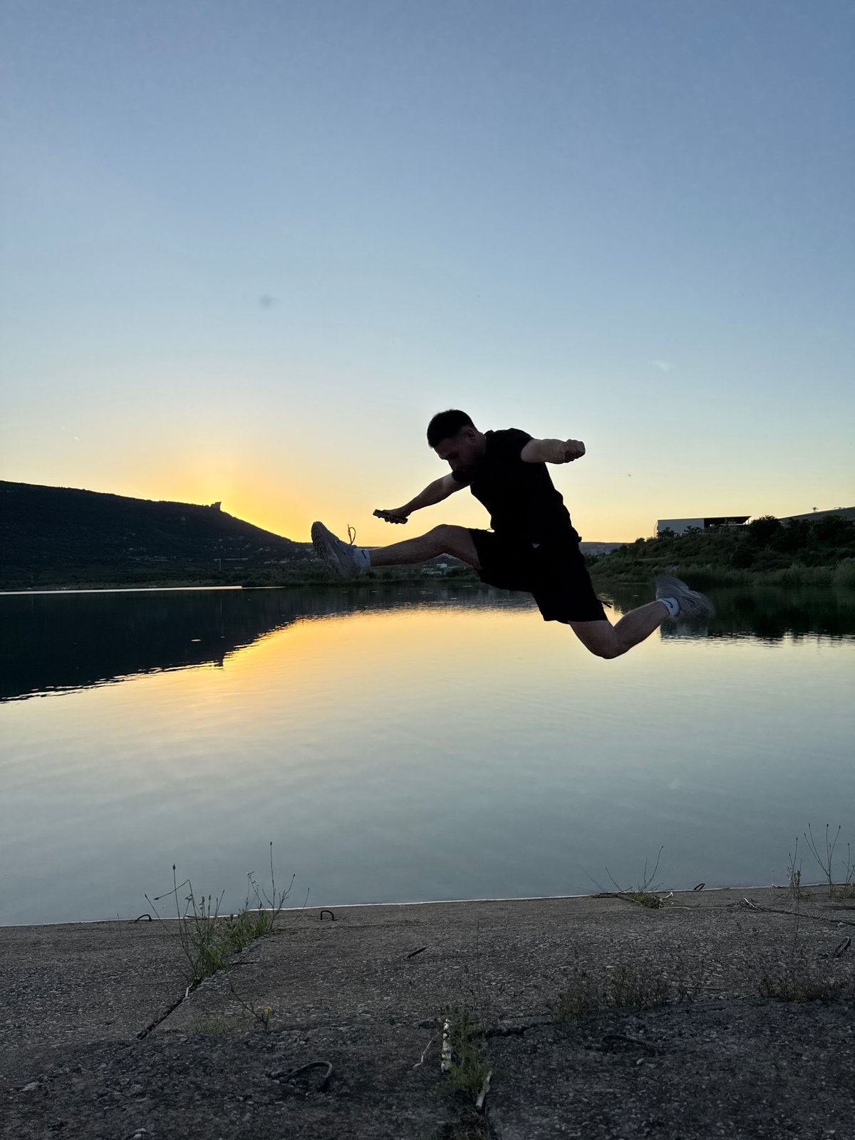 Jumping and flipping at a Shumen lakeside during golden hour