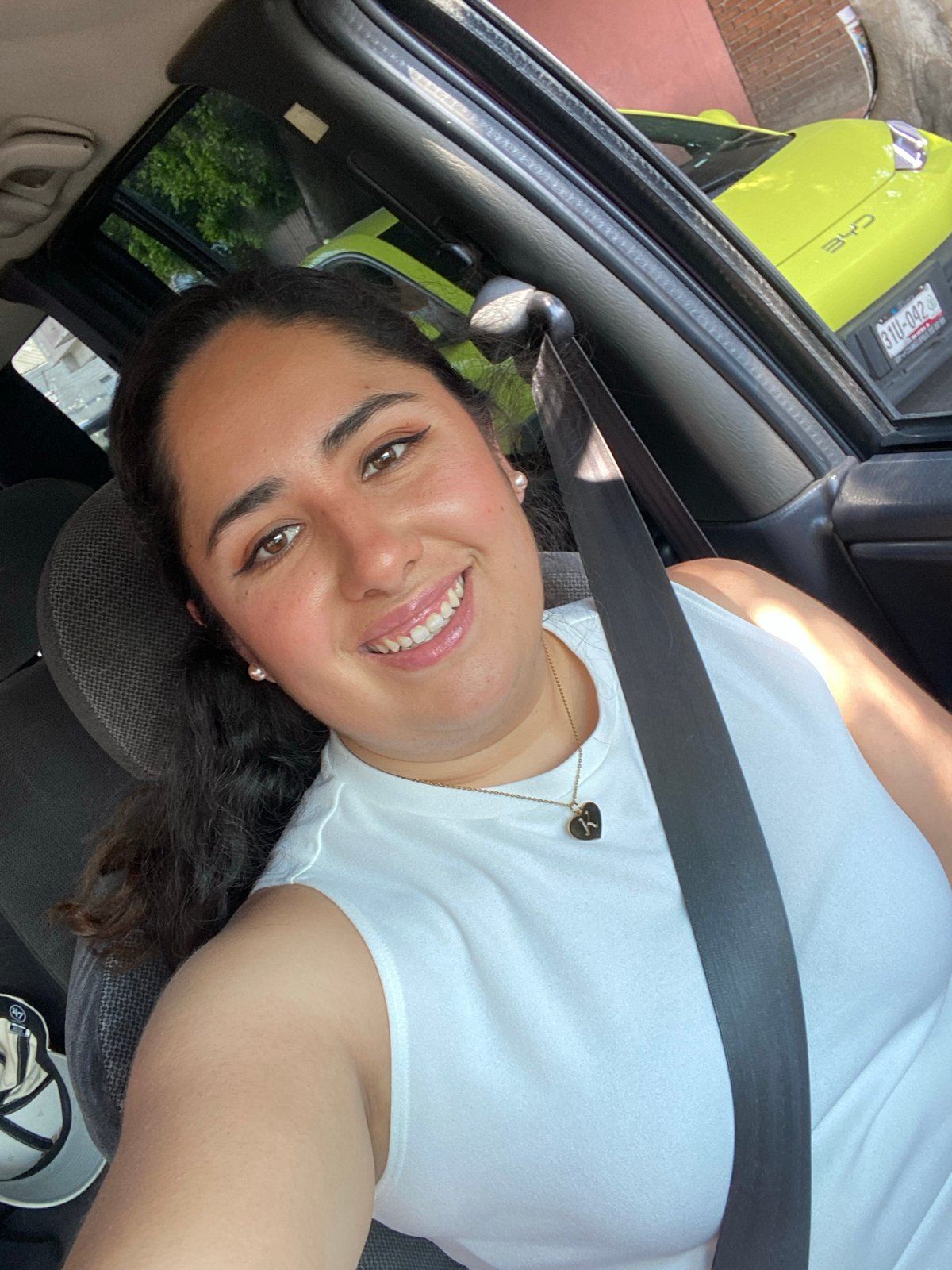 Woman photographed smiling in car in Puebla, Mexico