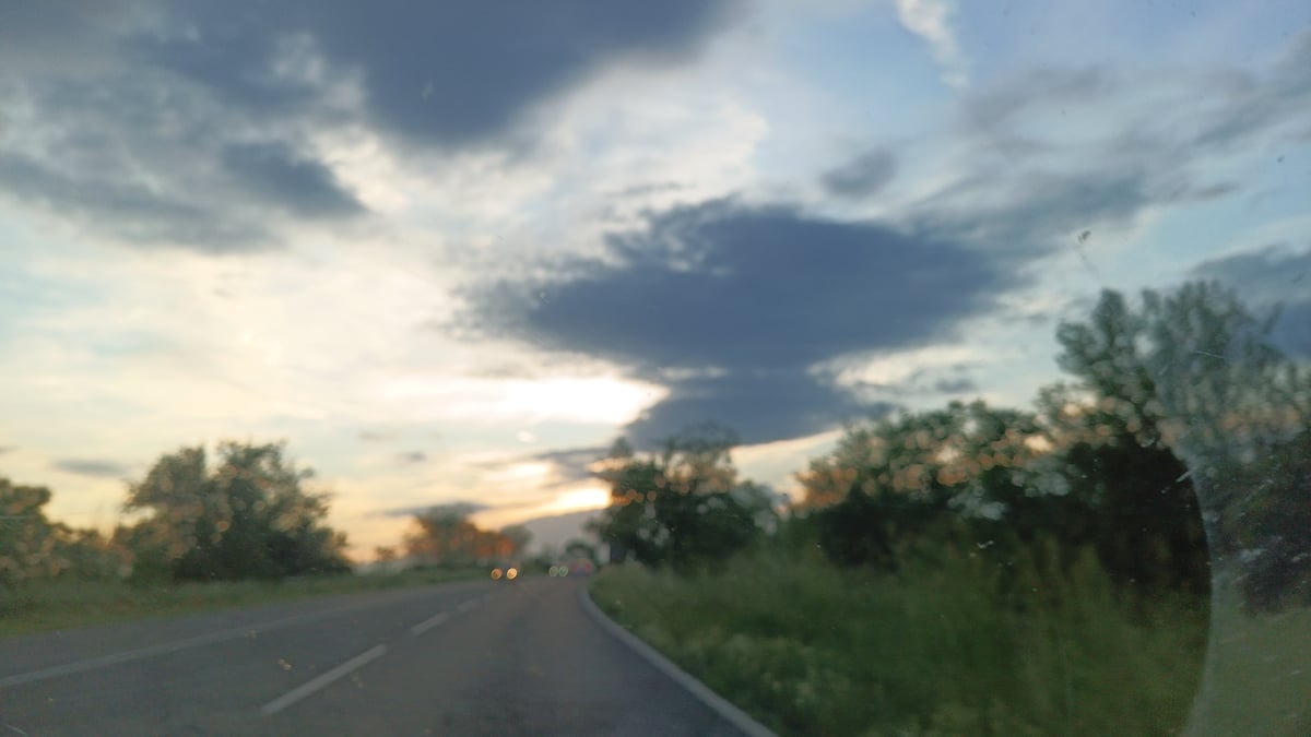 Evening traffic captured on tree-lined road near Burgas