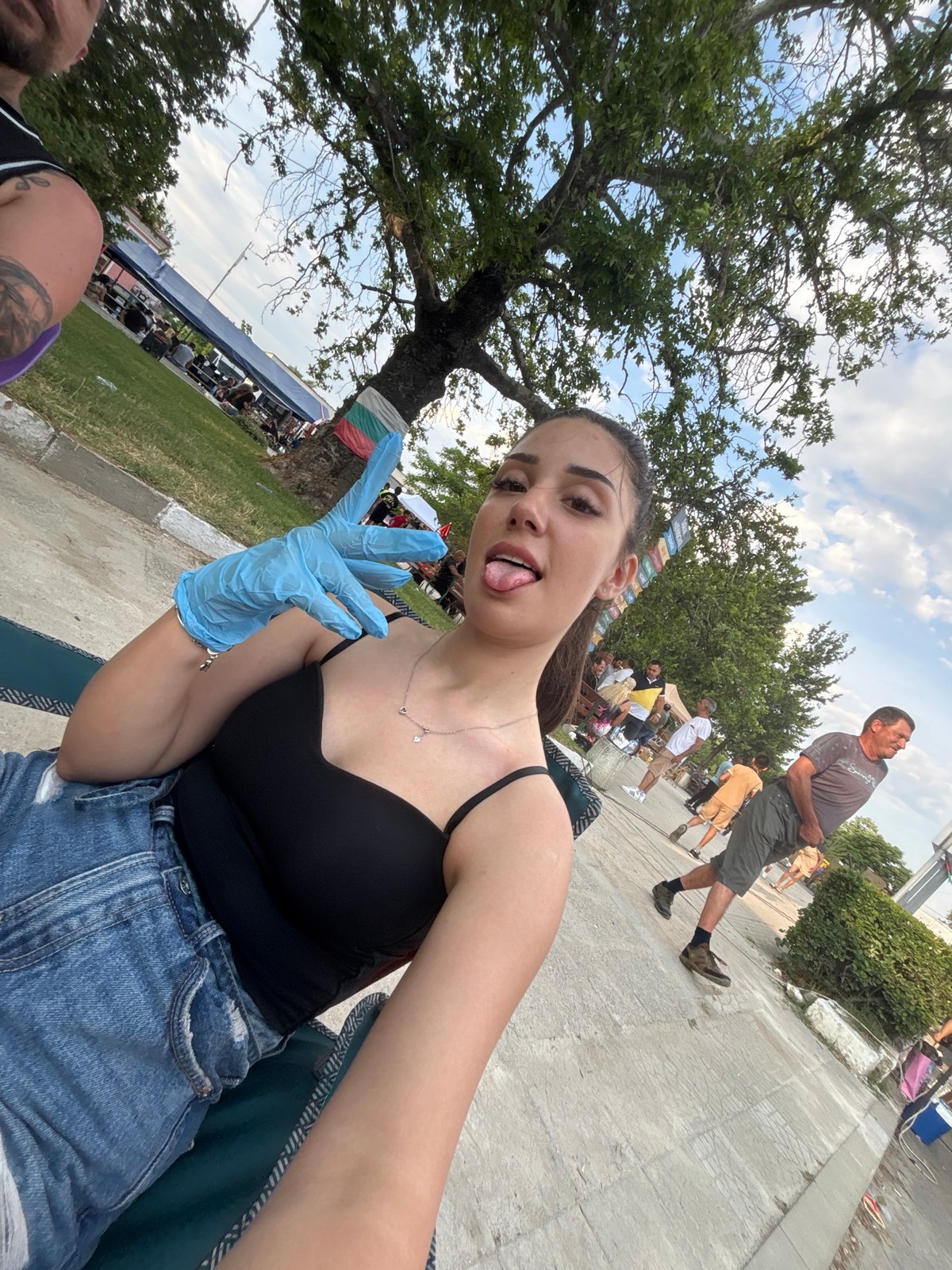 Woman takes selfies at outdoor market in Kostievo, Bulgaria