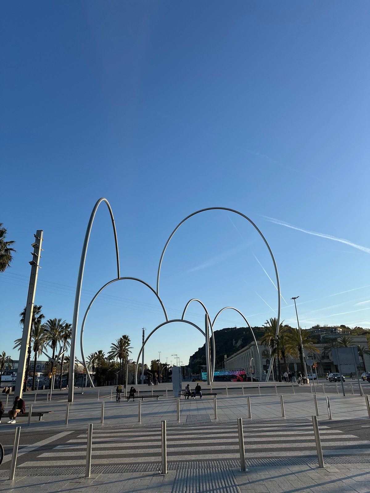 Tourist captures Barcelona Port Vell landmarks during afternoon stroll