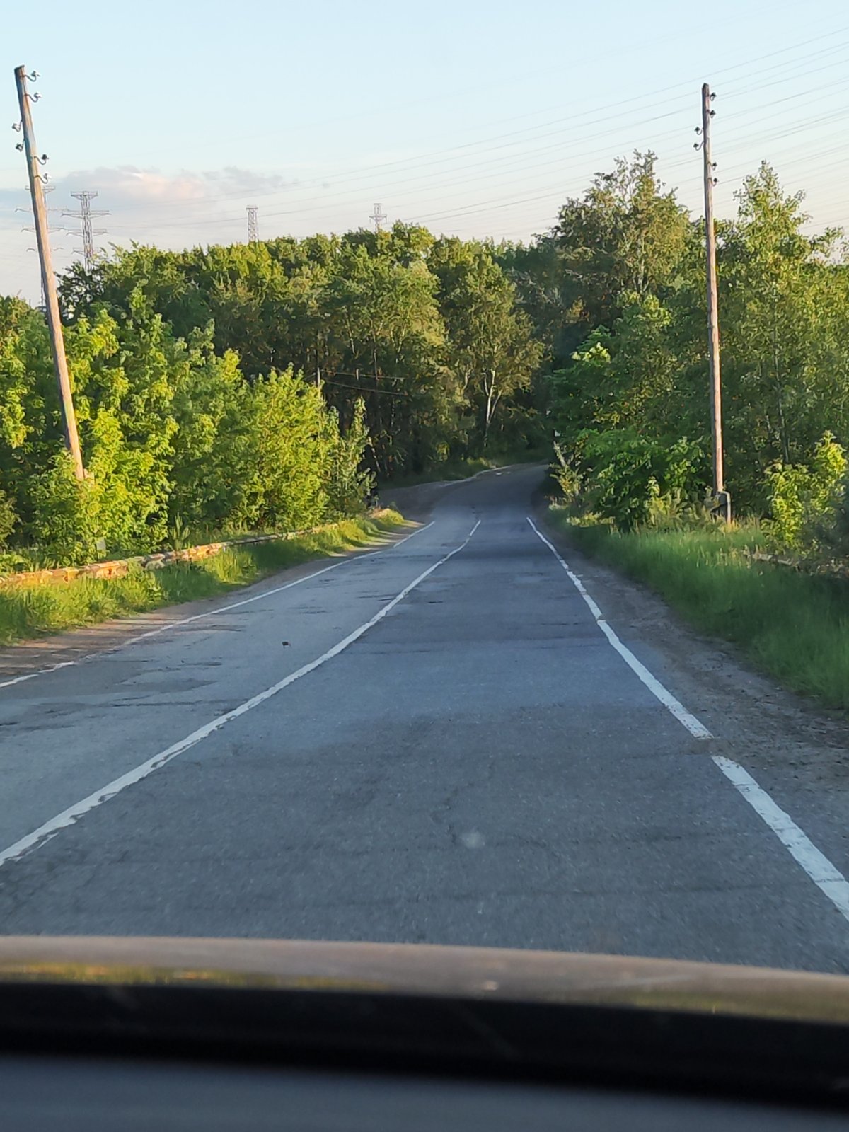 Vehicle journey documented through industrial Chaikovsky, Russia waterfront area