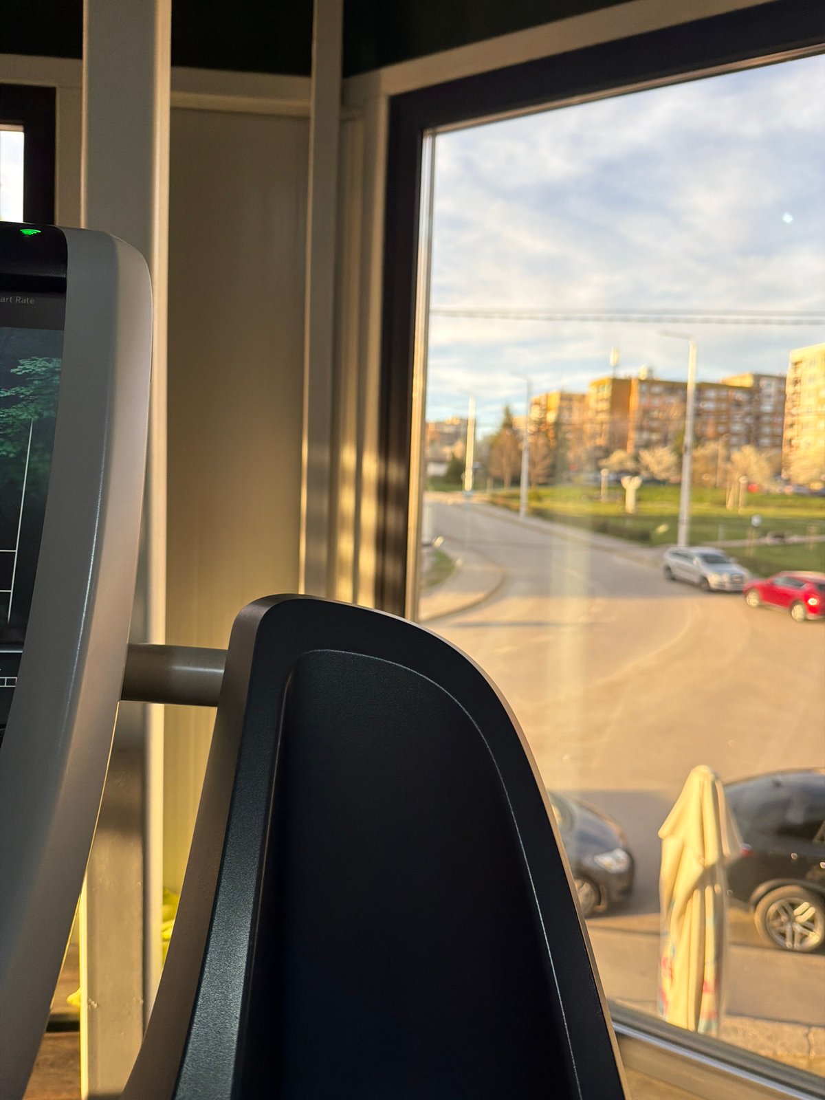 Window view captures everyday Pernik cityscape from indoor location
