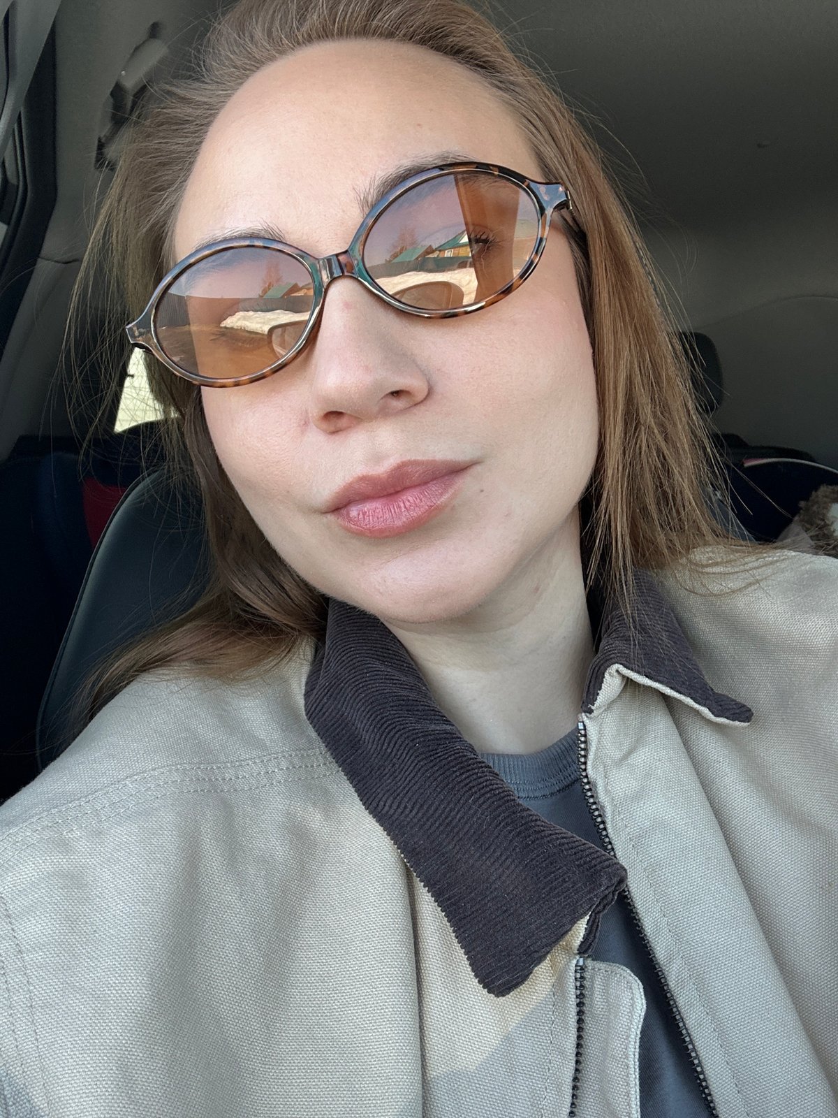 Woman takes selfies in vehicle, residence in Kharnavy, Russia