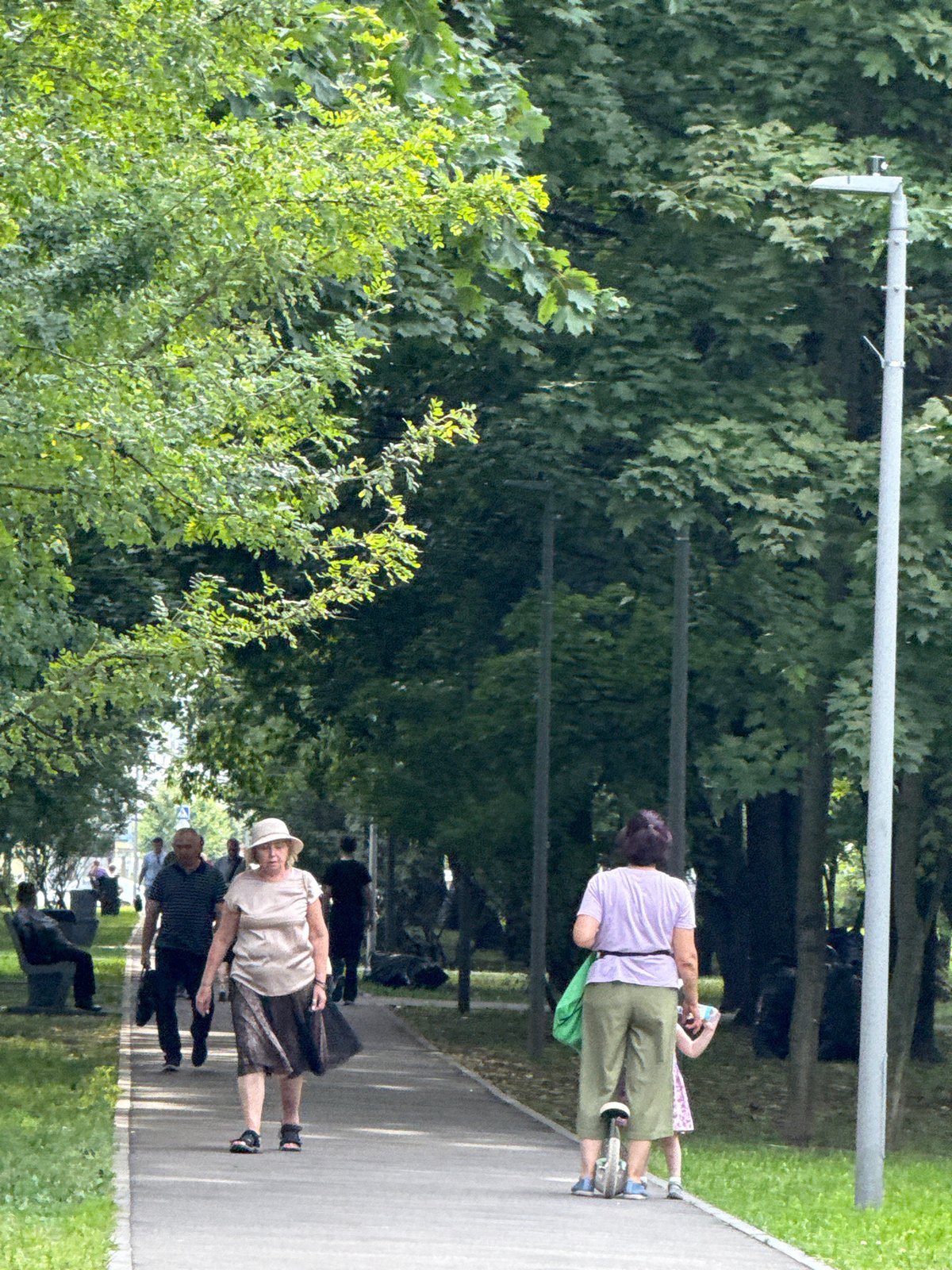 Summer afternoon stroll along a Moscow park boulevard