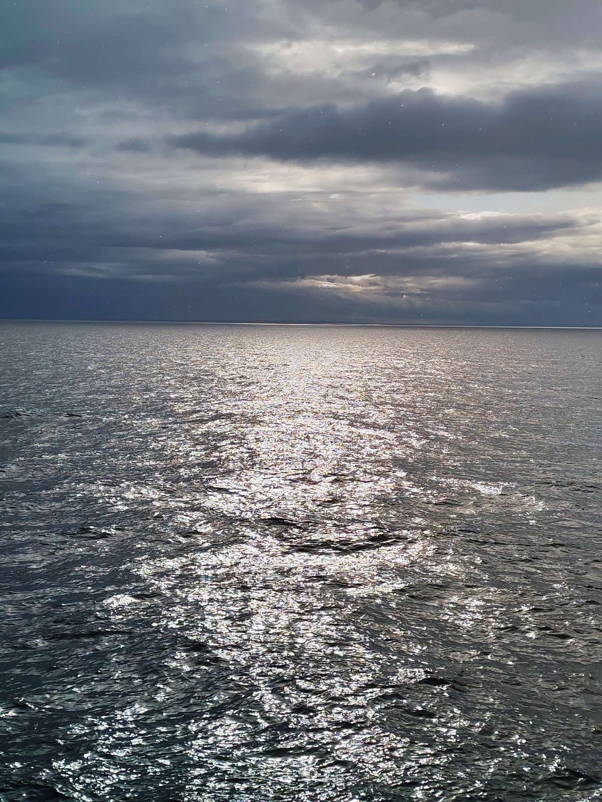 Overcast skies with sunlight breaks observed over Russian waters