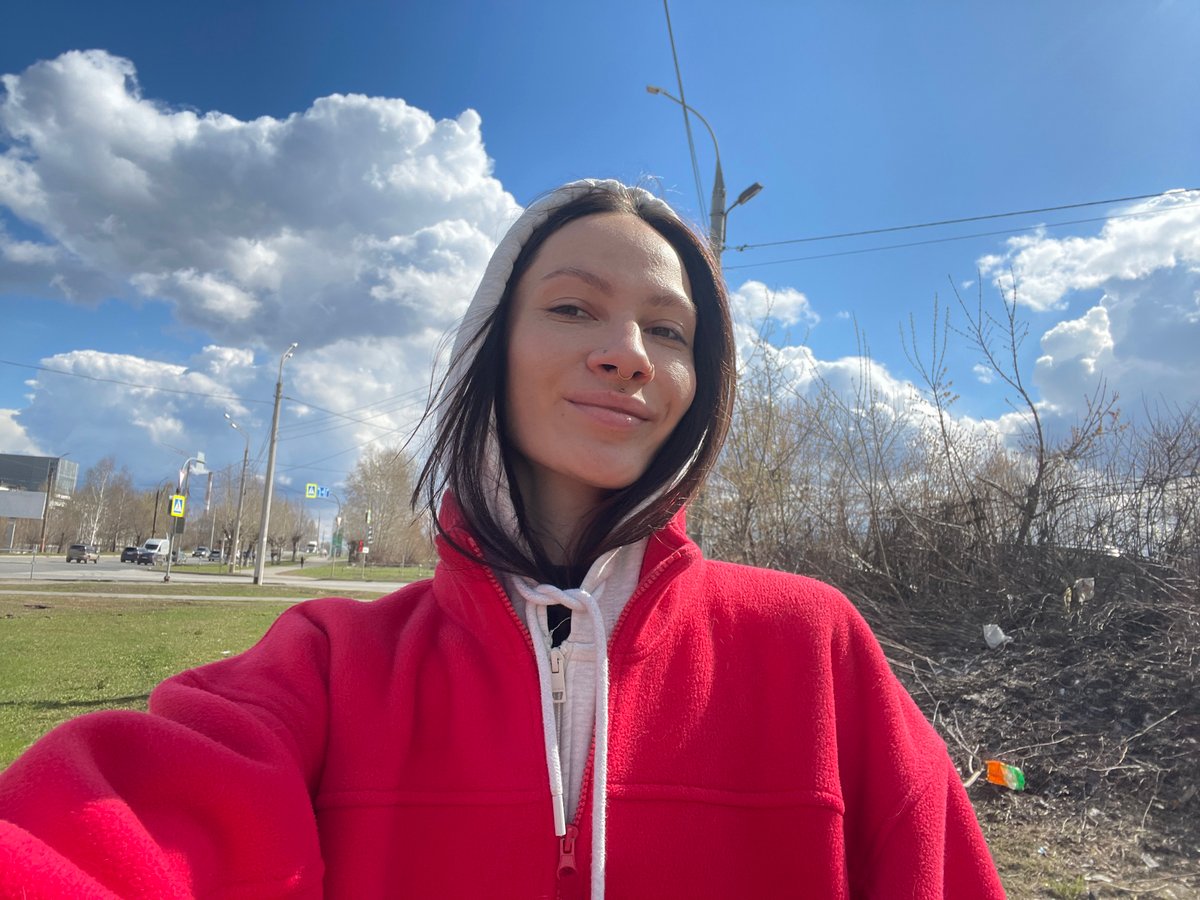 Woman takes morning selfies under cloudy sky in Izhevsk