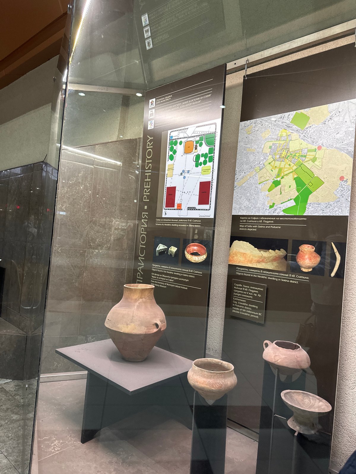 Museum visitor documents Sofia history exhibits, spots sleeping cat