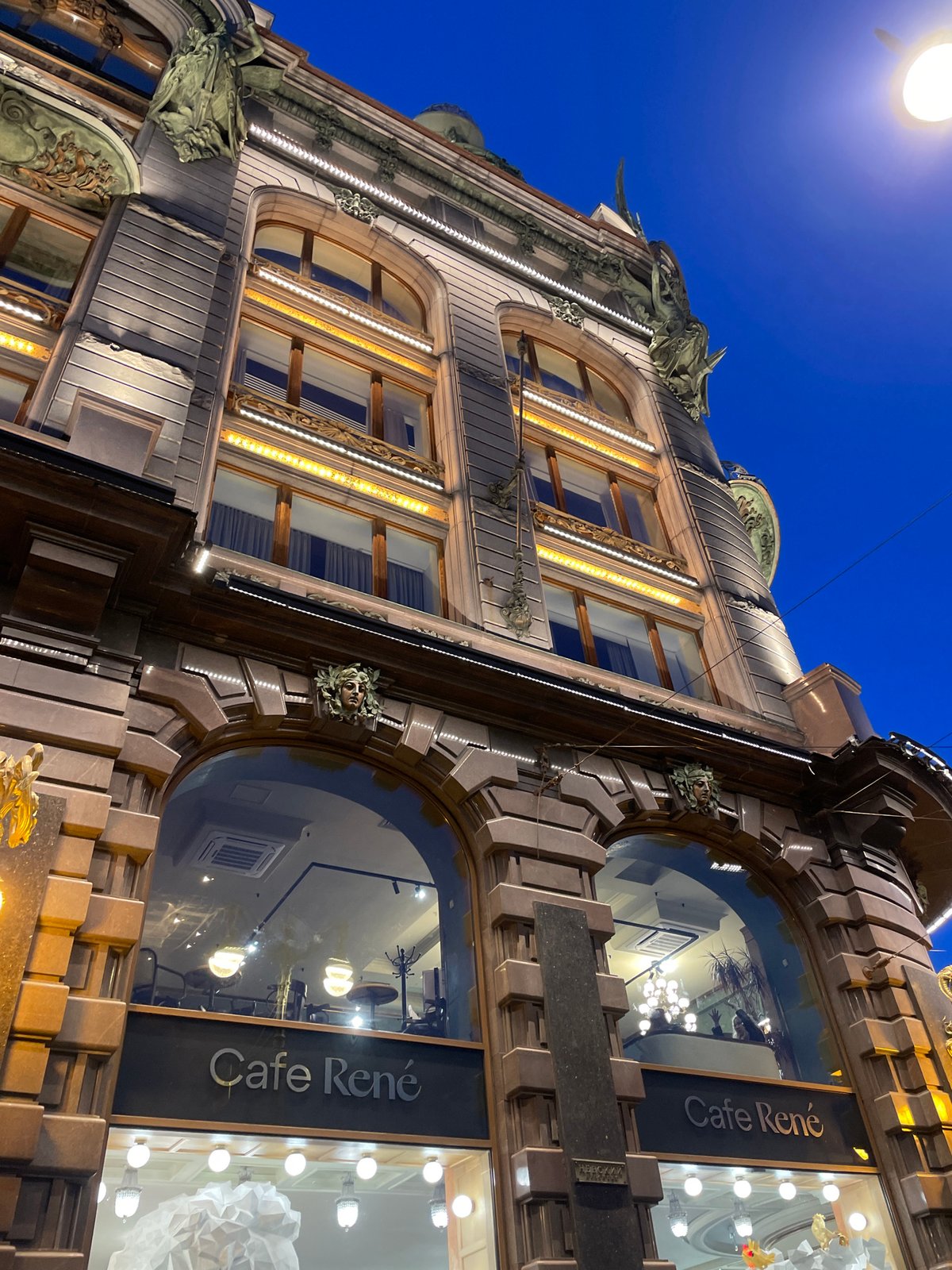 Ornate illuminated building photographed at night in Saint Petersburg