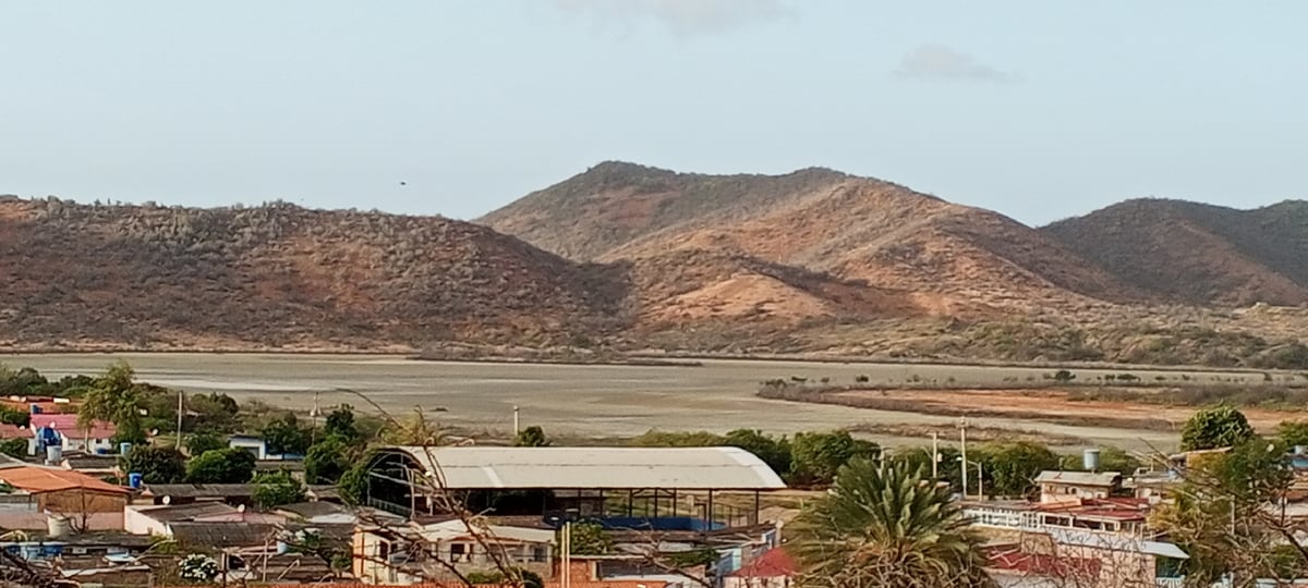 Juan Griego bay at golden hour, forts to fishing boats