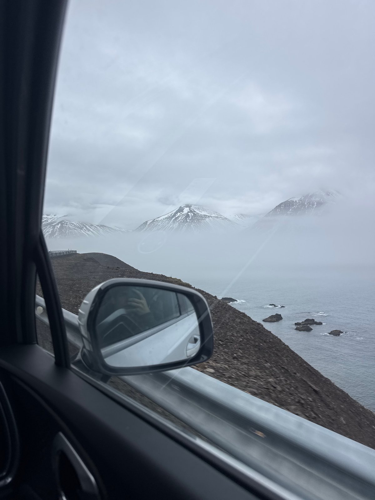 Traveler captures misty Iceland coastal views from vehicle