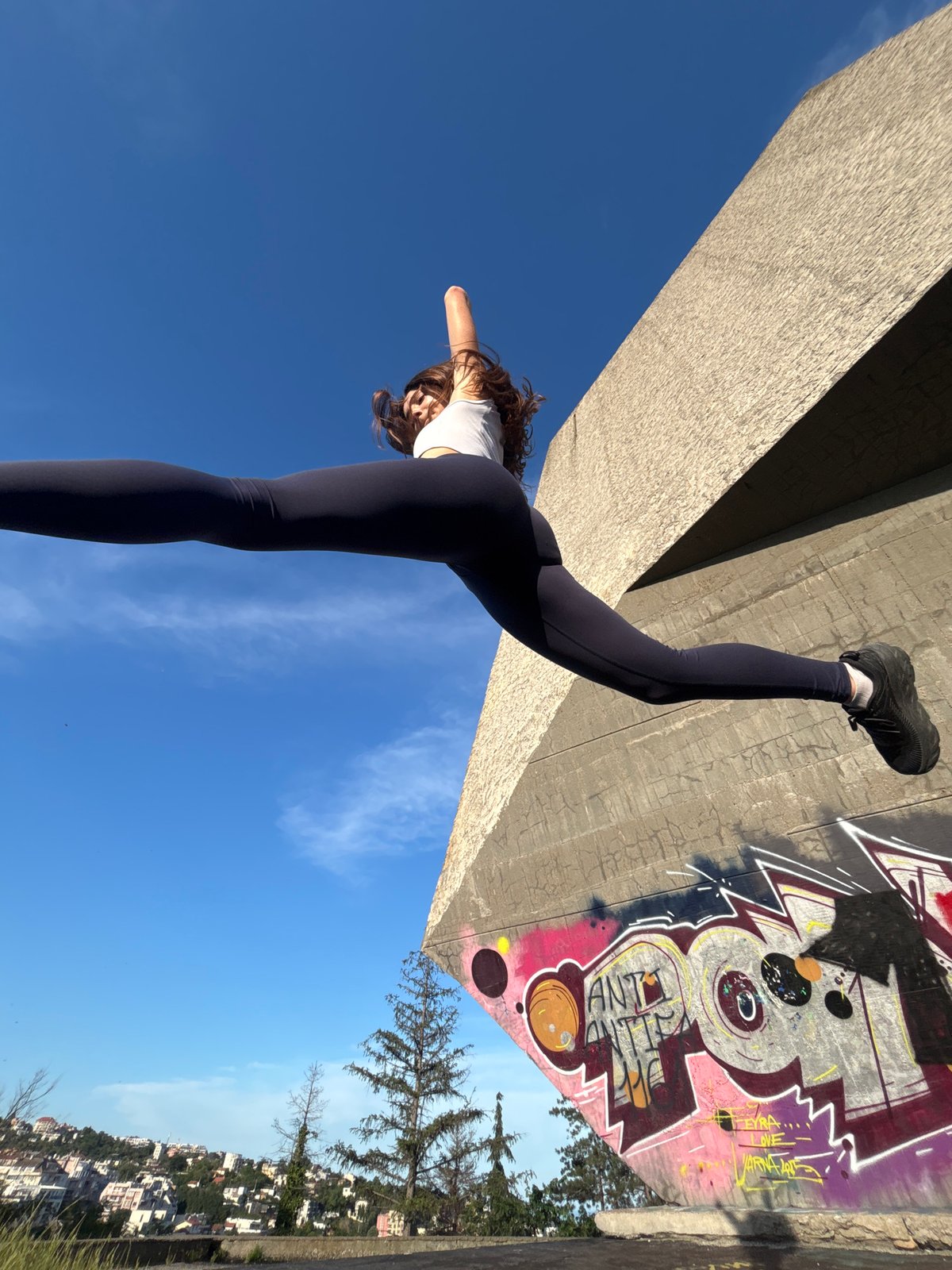 Athletic duo films parkour session at graffiti wall in Varna