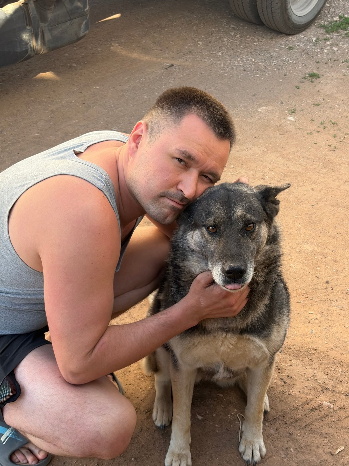 Man and dog share quiet moments on Izhevsk street