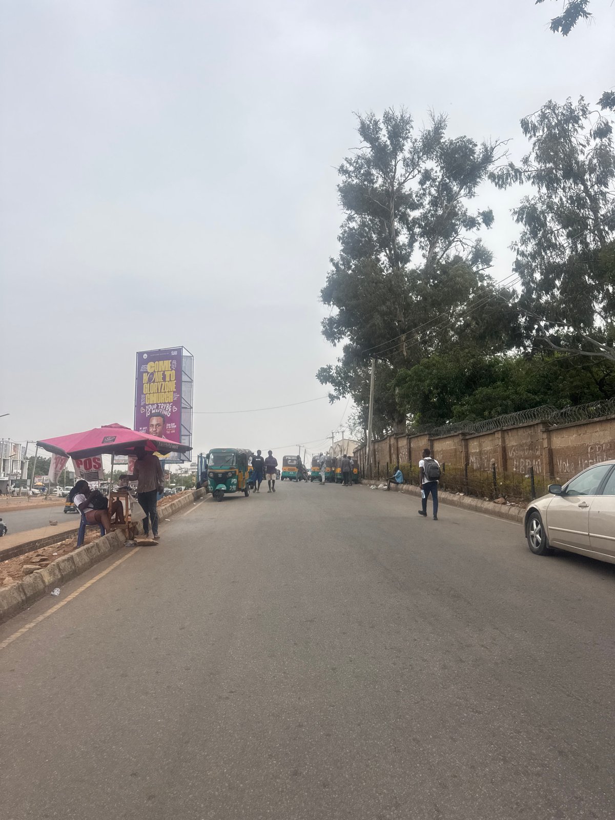 Street scene documented in Jos, Nigeria under overcast skies
