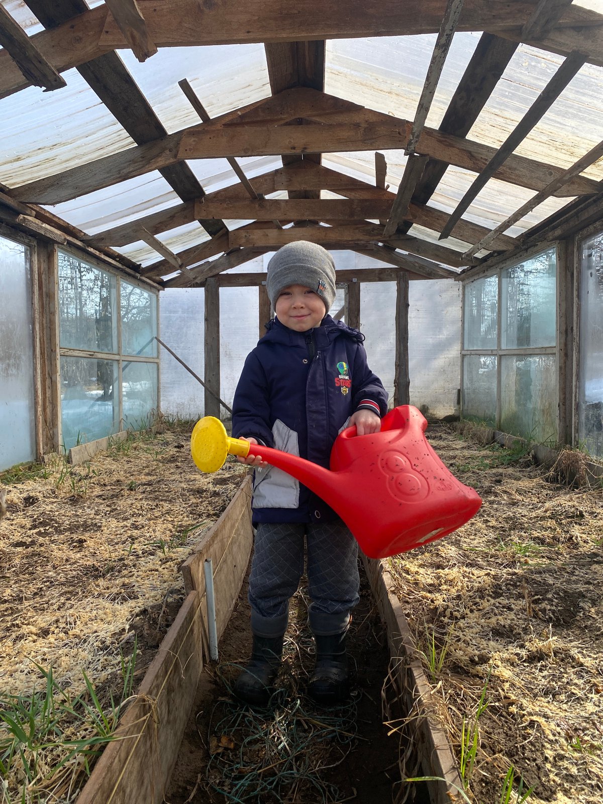 Child spotted with watering can, balance bike in Ольховка