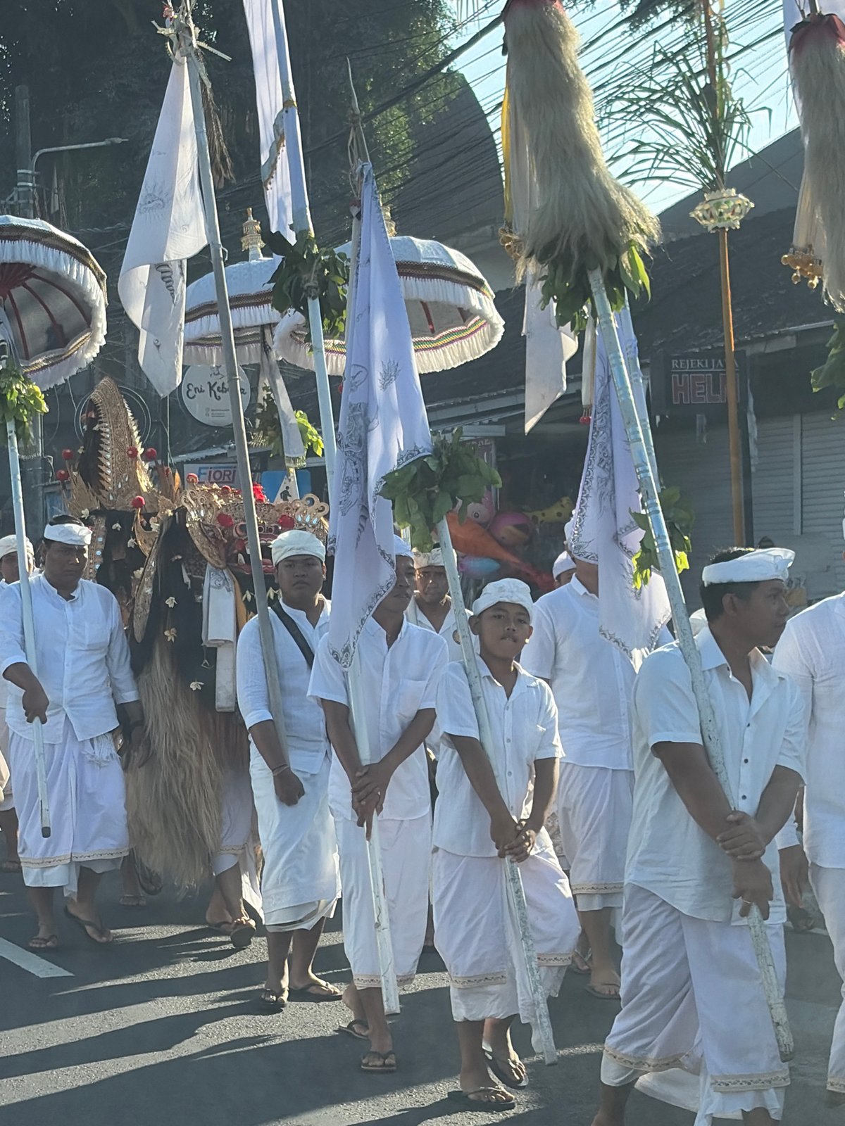Traditional procession with flags and ceremonial dress in Abiansemal