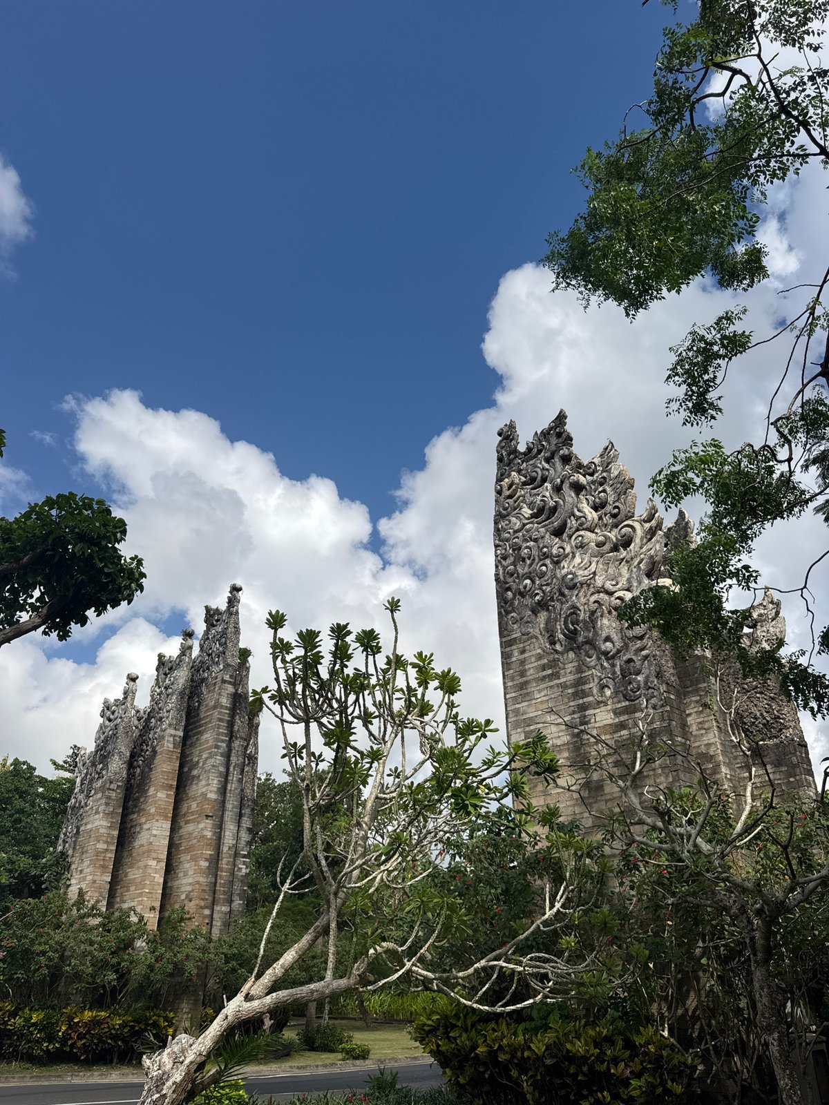 Tourist documents morning walk through ornate Kuta Selatan cultural site