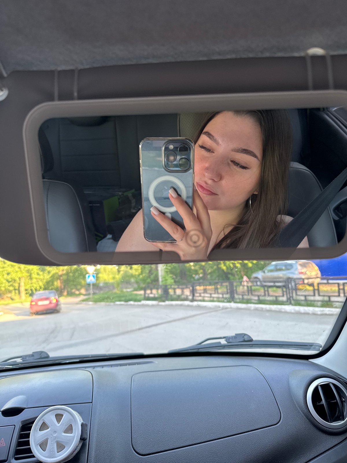Woman takes car mirror selfies in Perm