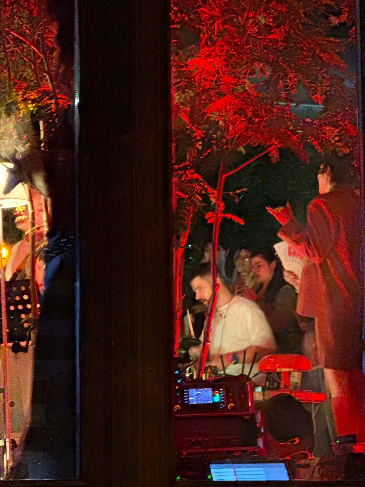 Window reflection captures two people in Moscow