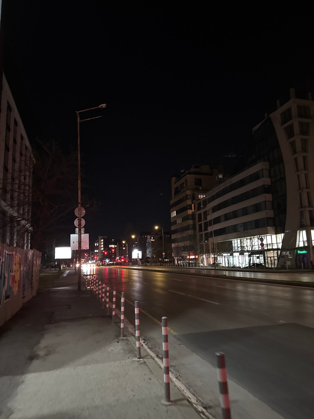 Wet nighttime street scene documented in Sofia, Bulgaria