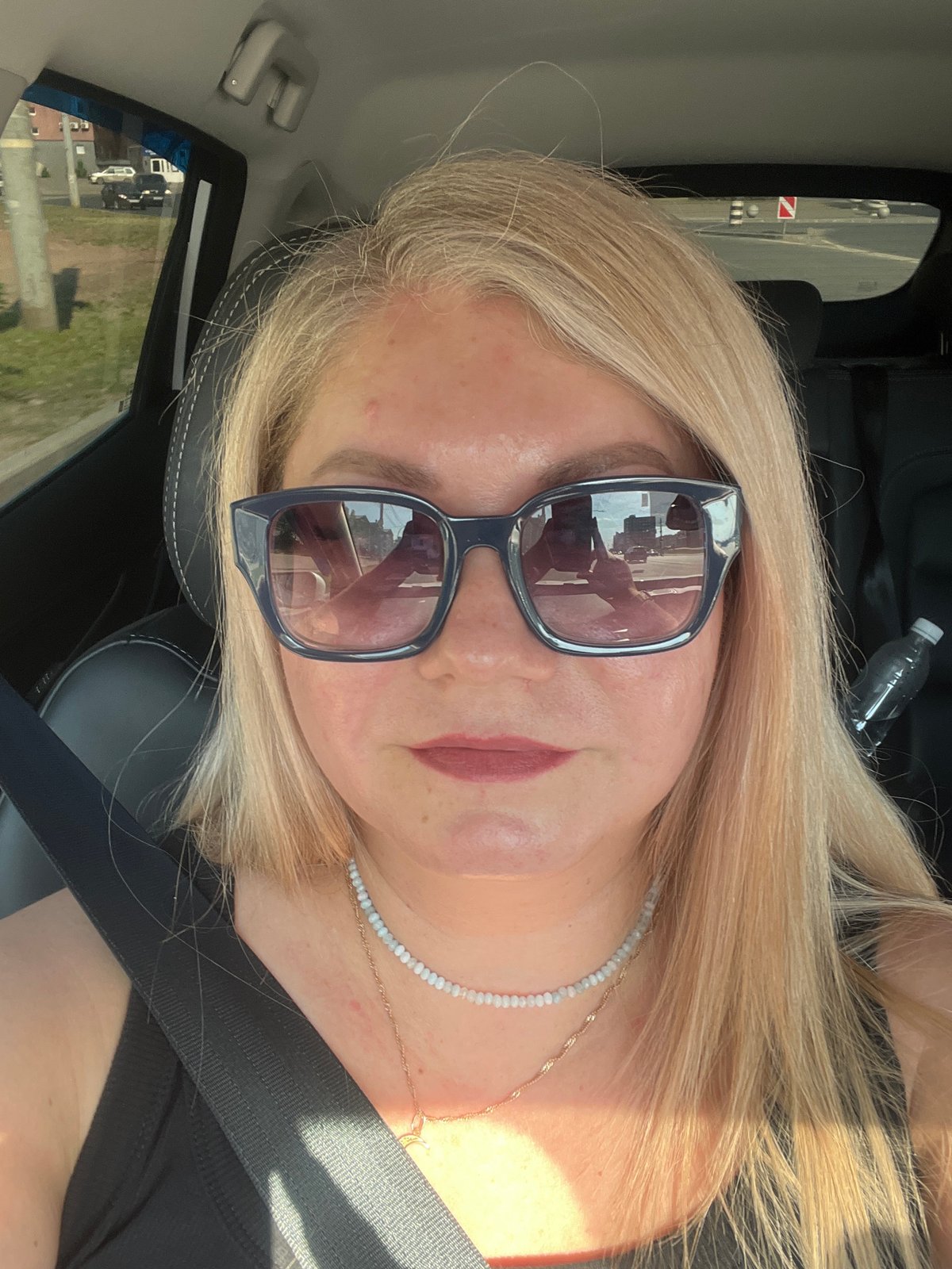 Woman in sunglasses observed in car in Izhevsk