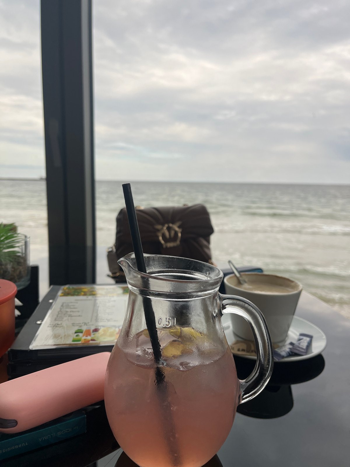 Man uses phone at seaside cafe in Varna
